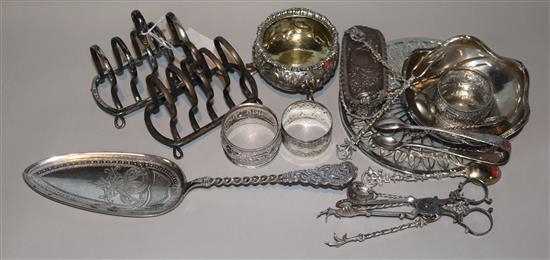 A pair of George V silver toast racks, three silver napkin rings and 14 other items